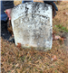 Photo of broken headstone being held up by clerk staff - Beckley Cemetery