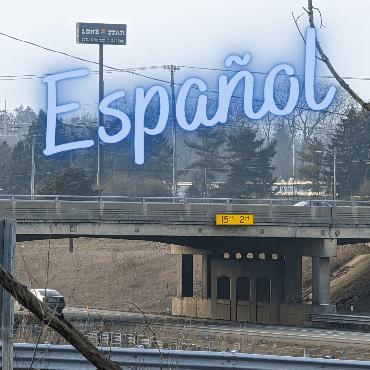 Standard road bridge in a city, with word Español over it.