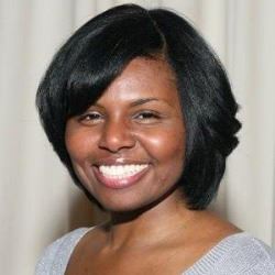 Head shot portrait of black woman with dark bobbed hair.