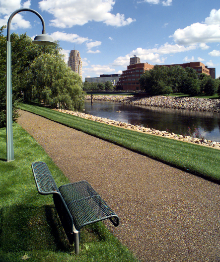 Pathway along the water with a bench and light