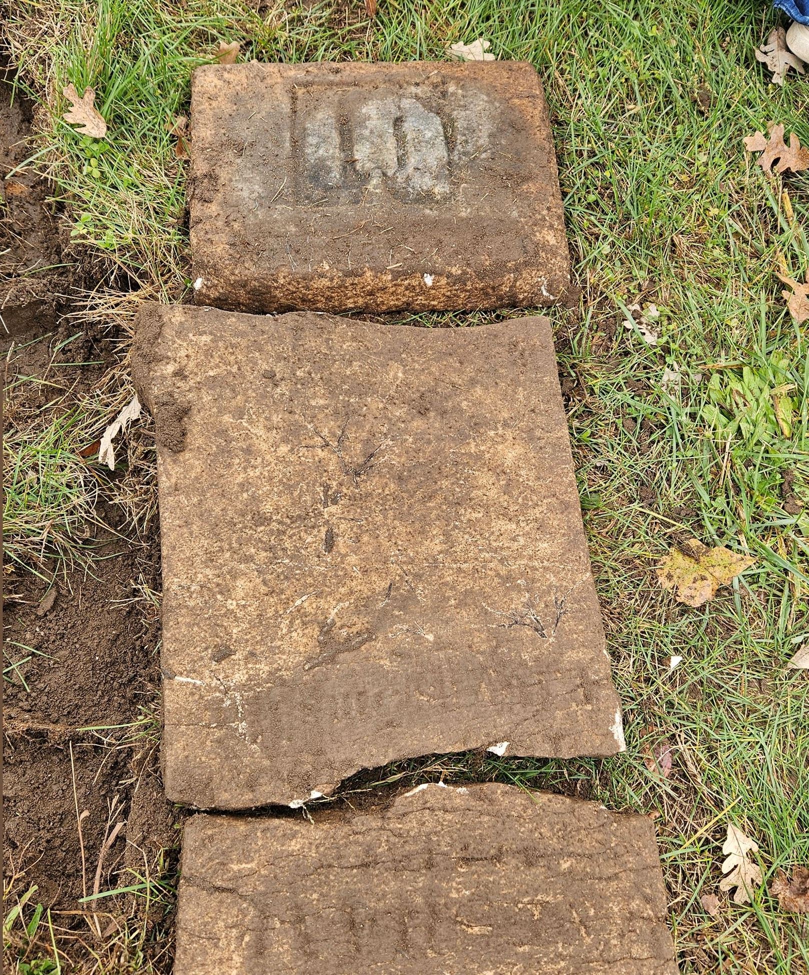 Photo of broken headstone that was buried under sod - Youngs Cemetery