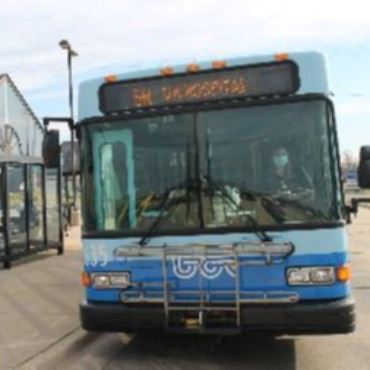 Battle Creek Transit bus stopped at a shelter at the downtown transfer center