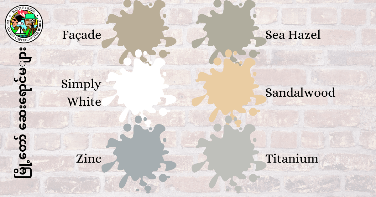 Paint splotches on brick façade with city paint program text in Burmese